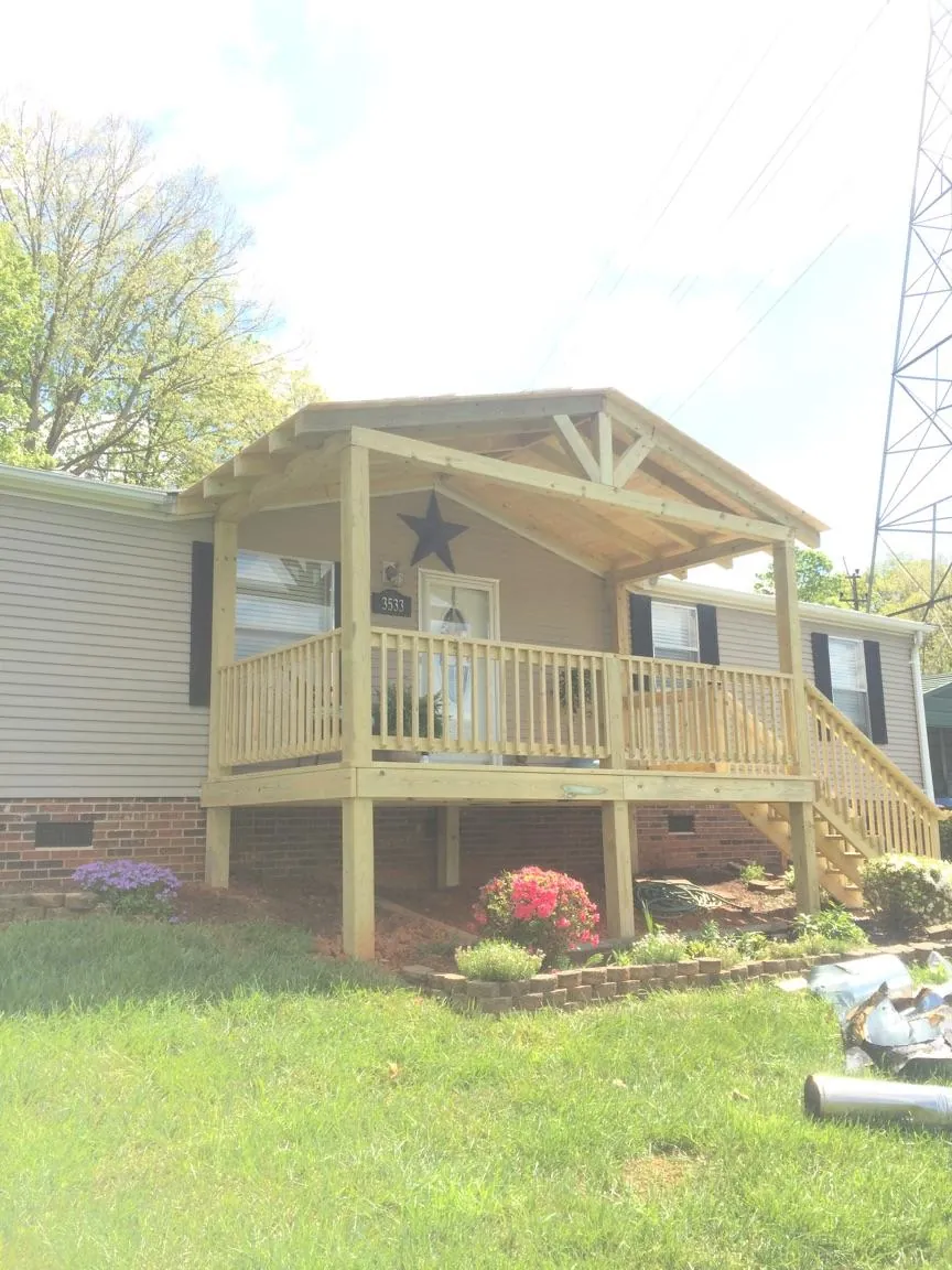 New gabled porch roof and deck railing added to a ranch home in Riverside
